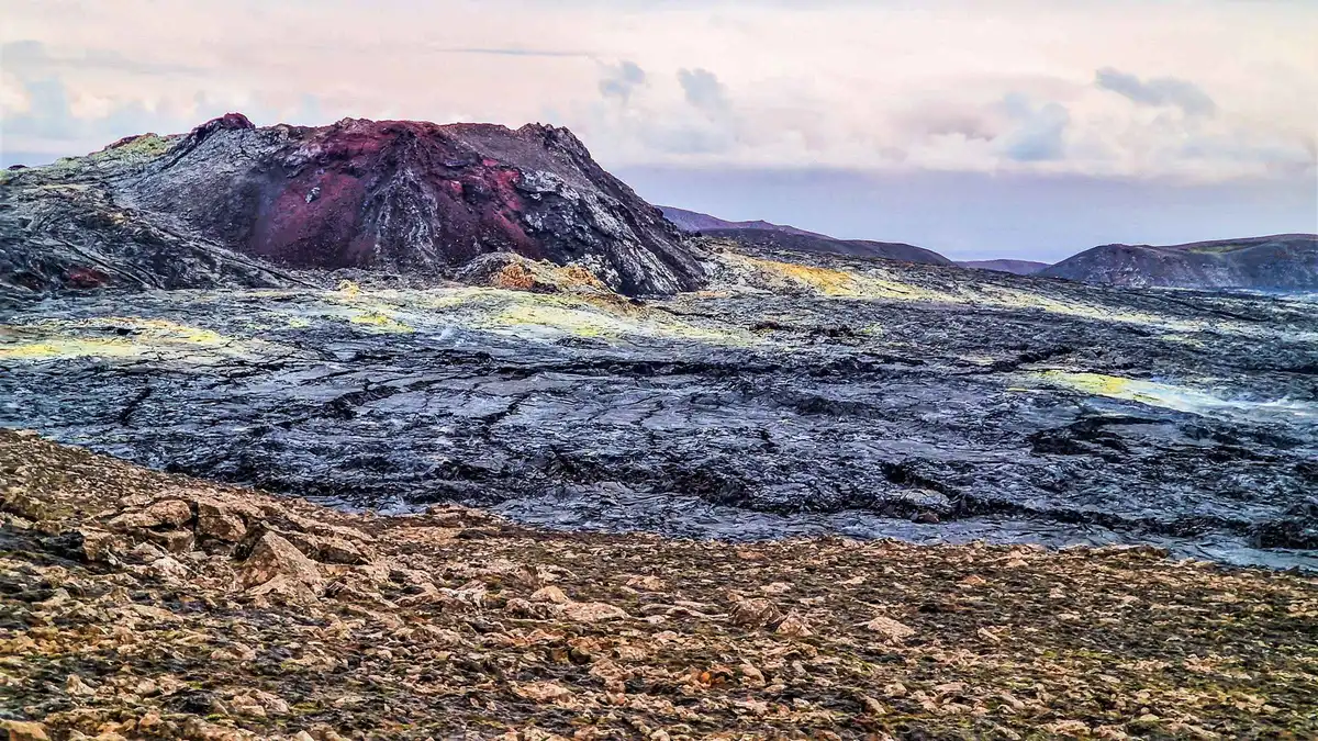Hikers on the trail through Geldingadalur Valley toward the Litli-Hrutur eruption site on a Fagradalsfjall volcano tour